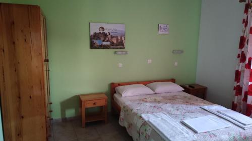 a small bedroom with a bed and a night stand at TRADITIONAL HOUSE ALEPIS IN AREOPOLIS in Areopolis