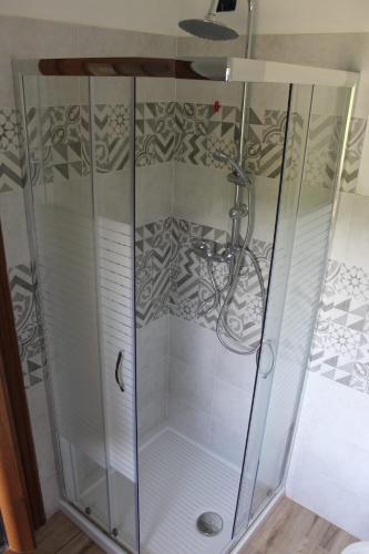 a shower with a glass enclosure in a bathroom at Casa Andreini in Mombarcaro