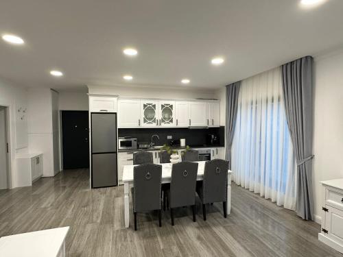 a kitchen with a table and chairs in a room at M&S Apartament 1 in Baile Felix