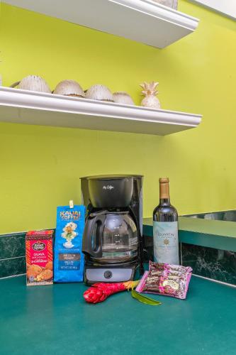 a counter with a coffee maker and a bottle of wine at Beautiful Poipu 1Br Condo with AC KP237 in Koloa