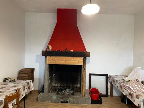a room with a fireplace with a red roof at B&B Bunela in Volpino