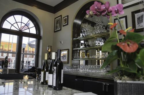 a bar with glasses and bottles of wine at The Bolling Wilson Hotel in Wytheville