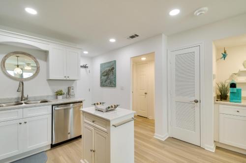 a kitchen with white cabinets and a sink at Gulf Shores Condo with Private Balcony on the Beach! in Gulf Highlands
