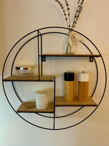 a round shelf with some candles on a wall at Noorden Stuuv in Wittenborn