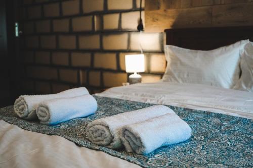 a bedroom with two beds with towels on them at Fiten house in Stepantsminda