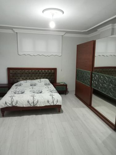 a bedroom with a bed and a cabinet in it at Kulaksız Köşk Villa in Rize