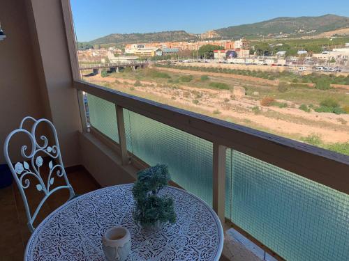 a table and chairs in a balcony with a view at Sagunto in Sagunto