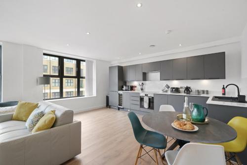 a living room and kitchen with a couch and a table at Modern Apartments in Vibrant Ramsgate in Kent