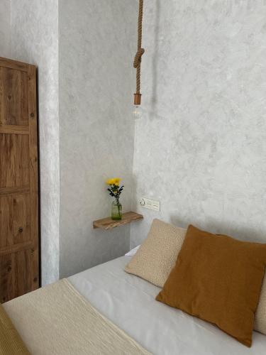 a bedroom with a bed and a vase of flowers at Casa Amodiño in Belesar