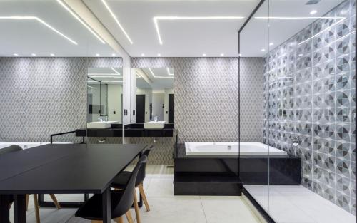 a bathroom with a black table and a bath tub at Drops Motel POA Zona Sul in Porto Alegre