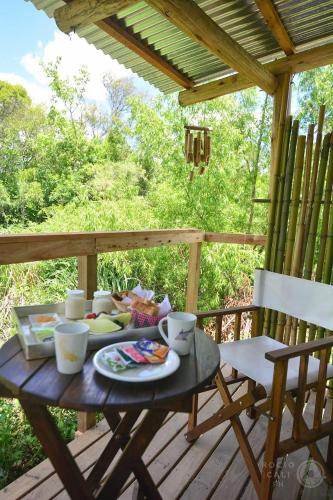 a wooden table with food on a deck at SUITE DEL BOSQUE Desayuno Domingos check out 17hs in Tigre