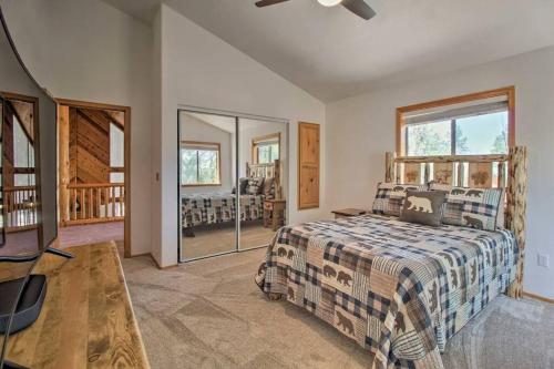 a bedroom with a bed and a large window at Pine Cone Cabin in Pinetop-Lakeside