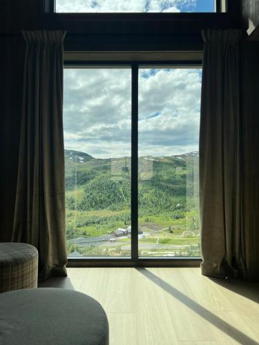a room with a large window with a view at Sogndal Chalet in Sogndal