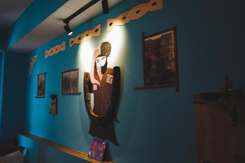 a wall with a painting of a bat on it at Fiten house in Stepantsminda