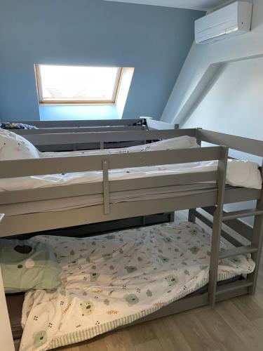 a bunk bed in a room with a window at Proche le pal in Diou