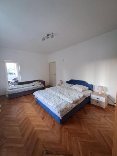 a bedroom with a bed and a wooden floor at Apartman Crno Jezero in Žabljak