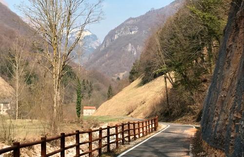 a road with a fence on the side of a mountain at Haus Granata Family - Trekking - Bike in Giazza