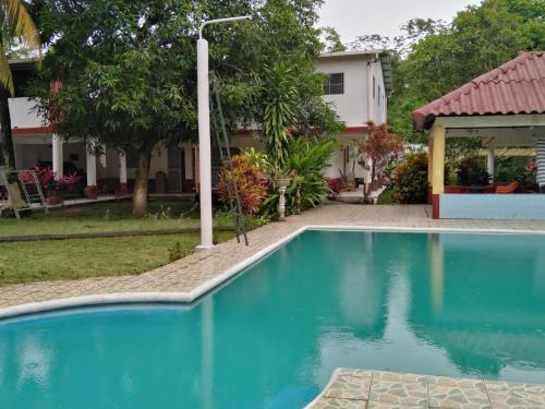 a swimming pool in front of a house at Chalet El Paraiso in Escuintla