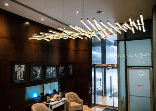 a chandelier in a room with a table and chairs at The Historic Blue Angel Hotel Lexington Ave, an Ascend Collection in New York