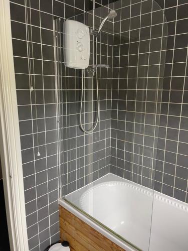 a bathroom with a shower and a bath tub at House number 12 sleeps up to 5 with Smart TVs in every room in Wellington