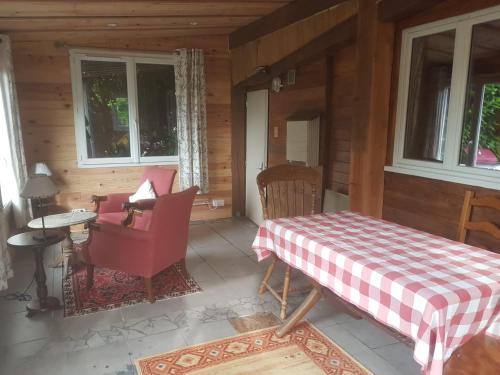a room with a table and chairs in a cabin at Holiday Chalet 2 Set in Country side in Bouteilles-Saint-Sébastien