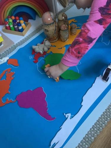 a child playing with a map of the world on a table at Family Break in Newmarket in Newmarket