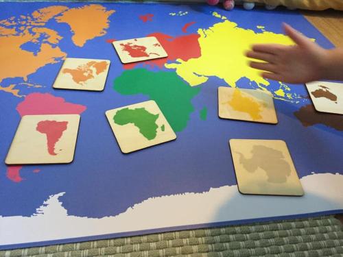 a child pointing at a map of the world at Family Break in Newmarket in Newmarket
