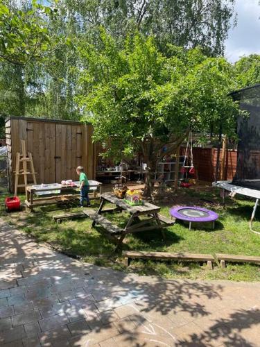 a backyard with a picnic table and a tree at Family Break in Newmarket in Newmarket