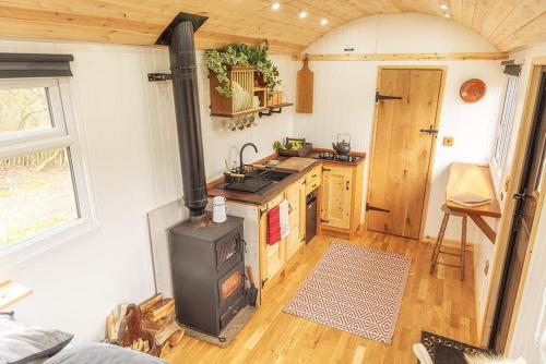 a kitchen with a stove top oven in a room at Homestead Hut 