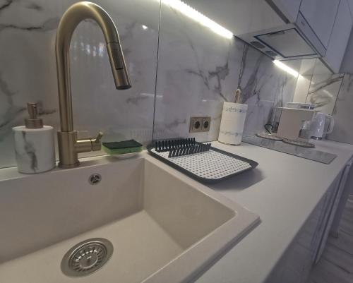 a kitchen counter with a sink and a faucet at Lindy V in Athens