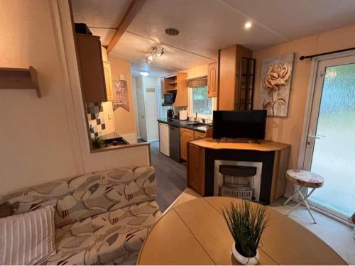 a kitchen and a living room with a laptop on a table at Holiday Home in Łacha