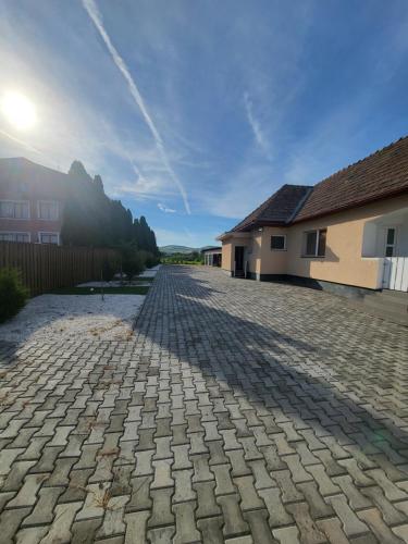 a cobblestone driveway in front of a house at Eduard House Room in Ungheni