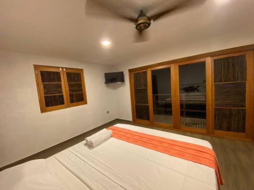 a bedroom with a bed and a ceiling at Hostal Recuerdos del Tayrona in El Zaino
