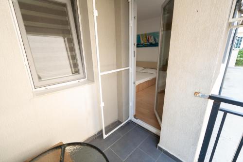 a room with a glass door and a window at Hotel Studio Titan in Bucharest