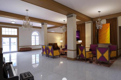 a lobby with purple and yellow chairs and tables at The Bolling Wilson Hotel in Wytheville