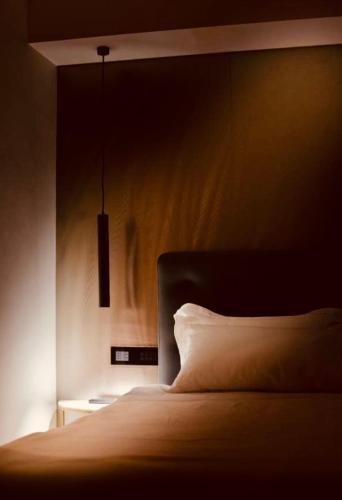 a bedroom with a bed with a white pillow at Boutique Hotel Sirmione in Sirmione