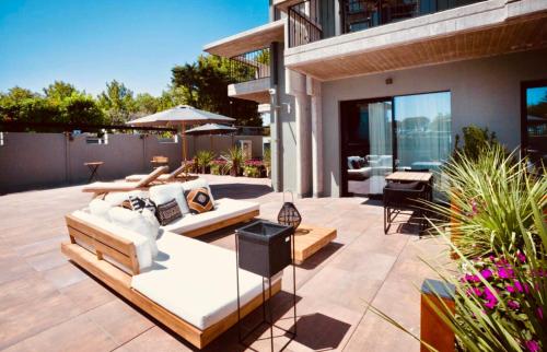 a patio with two couches and a grill at Boutique Hotel Sirmione in Sirmione