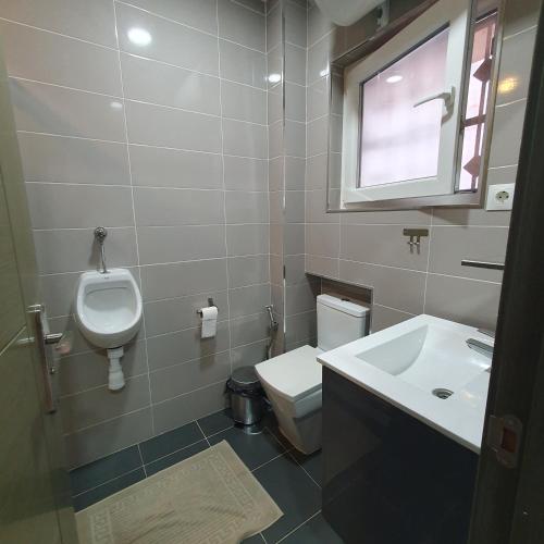 a bathroom with a sink and a toilet and a window at Studio in city in Fuengirola
