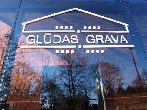 a reflection of a sign in the window of a store at Glūdas Grava in Cēsis
