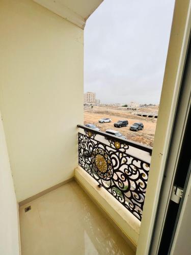 a balcony with a view of a parking lot at المزار للشقق الفندقية 1 in Salalah