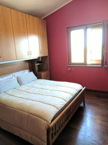 a bedroom with a large bed in a room with a window at Three bedroom Entire place in Roseto degli Abruzzi