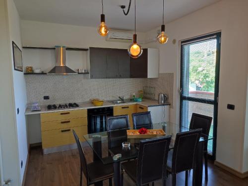 a kitchen with a table and chairs and a dining room at Villa Giuseppe in Roseto degli Abruzzi