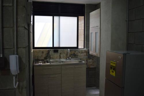 a small kitchen with a sink and a window at Apartamento en Cali in Cali