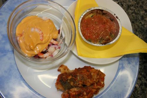 a plate with a bowl of food and a bowl of sauce at Hotel Miramare in Forte dei Marmi