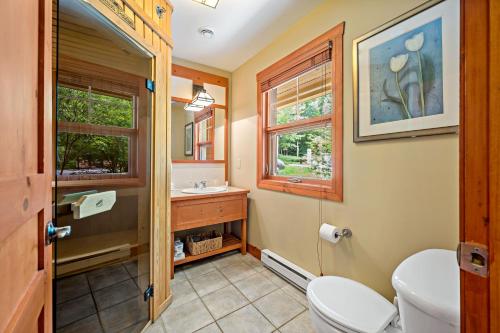 a bathroom with a toilet and a sink at Tremblant Les Eaux by Rendez-Vous Mont-Tremblant in Mont-Tremblant