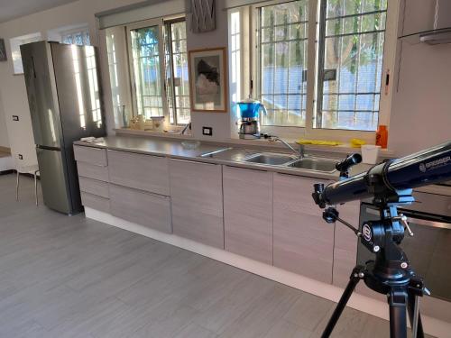 a camera taking a picture of a kitchen at Alloggio turistico Villa Camelia Lavinio in Anzio