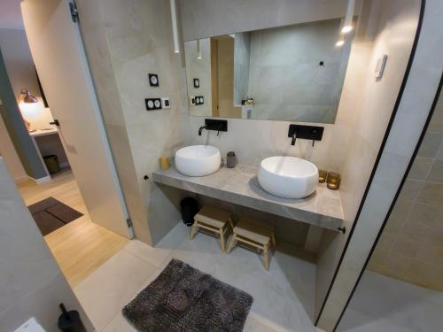 a bathroom with two sinks and a mirror at Like Home 1 Perfect Classic Duo in Świdnica