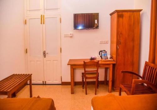 a room with a table and chairs and a door at Ace Boutique Airport in Katunayake