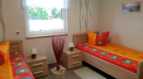a bedroom with two twin beds and a window at Ferienwohnung ILSENHOF in Königsbrück