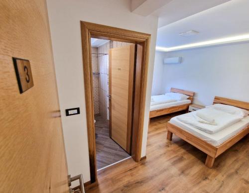 a small room with a bed and a mirror at Villa Sara in Sarajevo